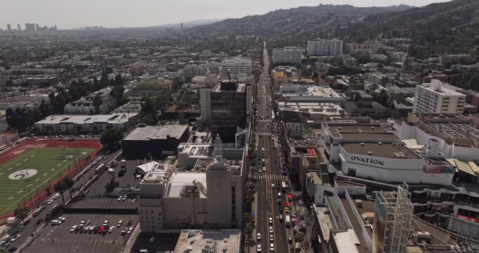 Los Angeles California Aerial v286 flyover above Hollywood Boulevard, revealing dense commercial cityscape, hillside neighborhoods and Hollywood Hills - Shot with Mavic 3 Pro Cine - May 26th 2024