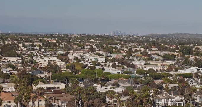 Santa Monica California Aerial v4 telephoto low flyover above Ocean Park, revealing downtown Santa Monica, Century City and dense coastal cityscape - Shot with Mavic 3 Pro Cine - May 25th 2024