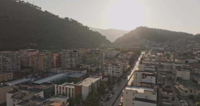 Berat Albania Aerial v19 low flyover across downtown residences toward Hotel Colombo, capturing dense cityscape and hillside at sunset - Shot with Mavic 3 Pro Cine - July 11th 2024