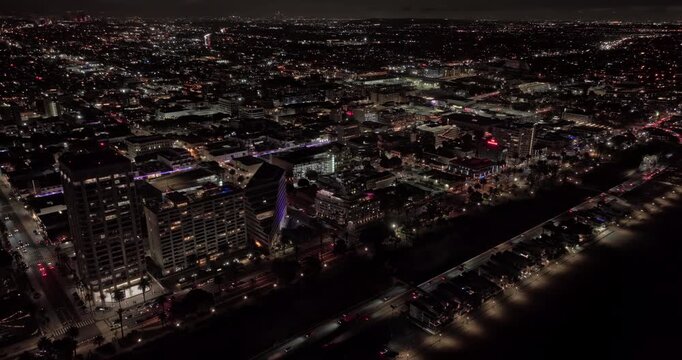 Santa Monica California Aerial v31 birds-eye orbit revealing State Beach, PCH, downtown, Third Street Promenade and illuminated pier at night - Shot with Mavic 3 Pro Cine - May 25th 2024