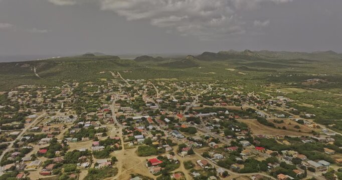 Bonaire Caribbean Netherlands Aerial v82 reverse flyover above Rincon, revealing residential townscape, parkland and rugged island hills - Shot with Mavic 3 Pro Cine - Feb 3rd 2024