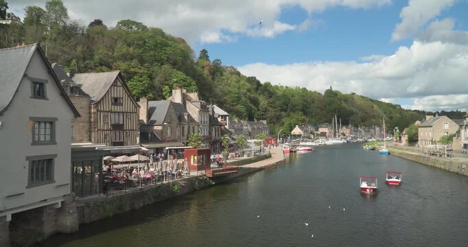 The port of the medieval city of Dinan with the old stone bridge that crosses the Rance River in Brittany, France