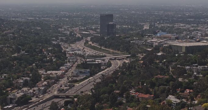 Los Angeles California Aerial v280 telephoto birds-eye flyover above Highway 101, revealing Universal City, Hollywood Hills neighborhoods and skyline - Shot with Mavic 3 Pro Cine - May 26th 2024