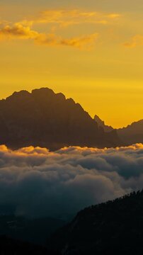 Vertical Timelapse of Sunrise Above Giu Pass, Italian Dolomites, Clouds and Fog Around Peaks