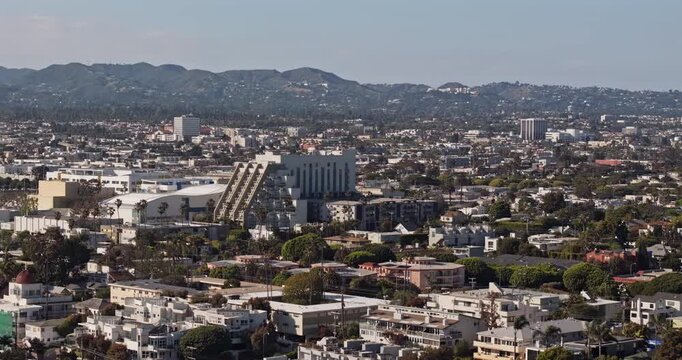 Santa Monica California Aerial v5 telephoto low flyover above Ocean Park, revealing downtown buildings, hillside skyline and dense coastal neighborhoods - Shot with Mavic 3 Pro Cine - May 25th 2024
