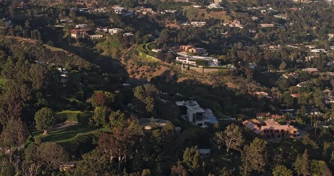Los Angeles California Aerial v305 telephoto birds-eye orbit above Bel Air, showcasing secluded hillside mansions, landscaped estates and winding roads - Shot with Mavic 3 Pro Cine - May 26th 2024