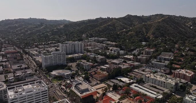 Los Angeles California Aerial v294 orbiting flyover above Hollywood Boulevard buildings, revealing dense cityscape and Hollywood Hills neighborhoods - Shot with Mavic 3 Pro Cine - May 26th 2024