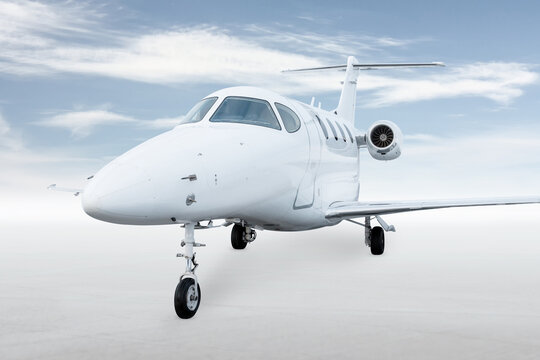 Modern white business jet isolated on bright background with sky