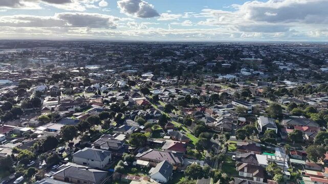 Aerial view of suburban neighborhood houses flying forward