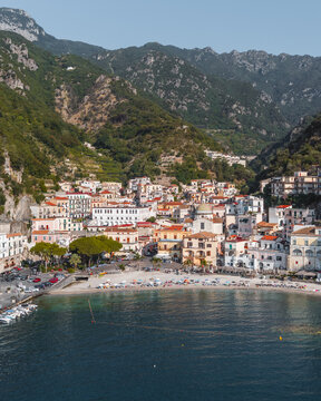 Aerial view of the coastal village of Cetara with its colorful buildings, beach, and surrounding mountains in Cetara, Amalfi Coast, Campania, Italy.