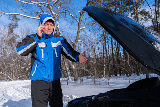 Man call roadside assistance for winter car breakdown