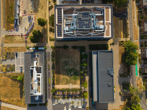 Aerial view of the Resmed UK research campus with modern office buildings, rooftop solar panels, and landscaped grounds in Didcot, England, United Kingdom.