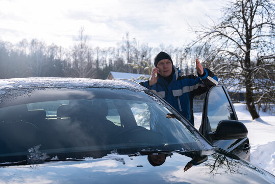 Driver call roadside assistance after winter car breakdown