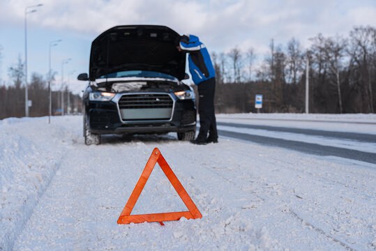 Emergency car breakdown on snowy winter roadside