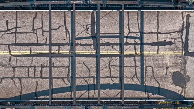Aerial view of Spring Gulch bridge deck featuring asphalt pavement with visible crack seal repairs and structural steel framework in Clear Creek County, Colorado, United States.