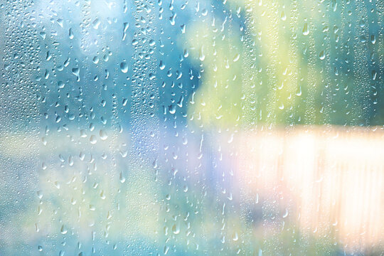 Light green gradient raindrops on glass abstract blurred background gentle summer soft green