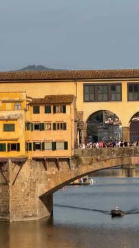 Close-up view of Ponte Vecchio over the Arno River in Florence, Tuscany, Italy. Historic medieval bridge with traditional buildings, iconic Renaissance landmark and popular tourist destination.