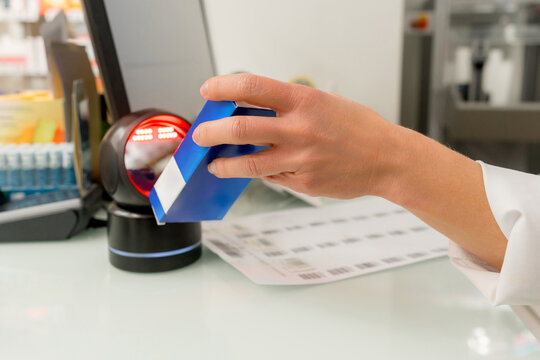 Pharmacist scan medicine package at pharmacy counter