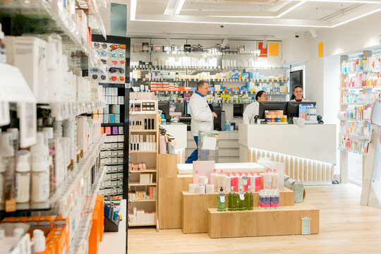 Pharmacy interior with pharmacist and medicine display