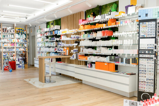 Modern pharmacy interior with medicine shelves and eyewear display