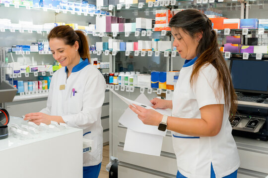 Pharmacy staff check medicine inventory and prescription order