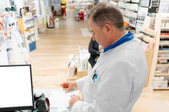 Pharmacist process prescription at pharmacy counter