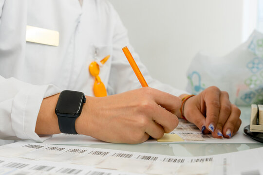 Pharmacist writing a note in a pharmacy