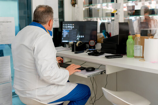Pharmacist work at computer in pharmacy dispensary
