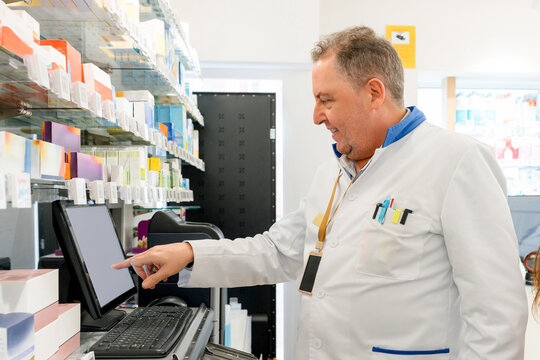 Pharmacist use computer in pharmacy medicine dispensary