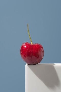 Jerte Picota cherry with water drops on blue background