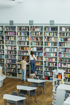 Teenagers collaborating on studies in a vibrant school library setting