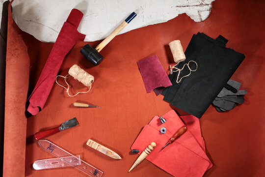 Working tools of tanner for cutting leather. Genuine leather for making products and accessories. Manufacture of accessories made of natural or artificial leather. Handmade work. Top view