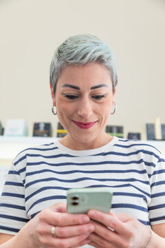 Professional esthetician use smartphone in skincare clinic