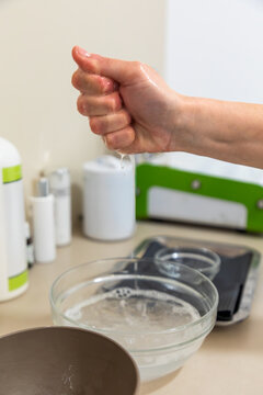 Hand squeezing water for skincare treatment preparation