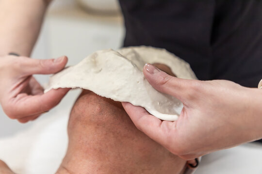 Removing dried facial mask during professional skincare treatment