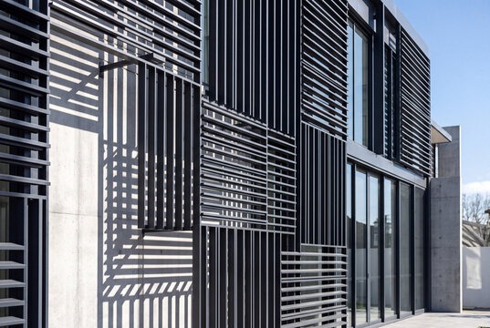 Modern Architectural Facade with Metal Louvers, Sunshade Screens and Contemporary Exterior Design