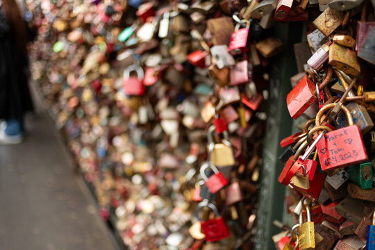 Horizontal view of red love padlocks attached to the Hohenzollern Bridge fence with a blurred perspective in Cologne