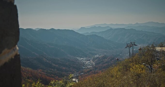 Aerial View of Cable Cars Over Autumnal Mountain Range