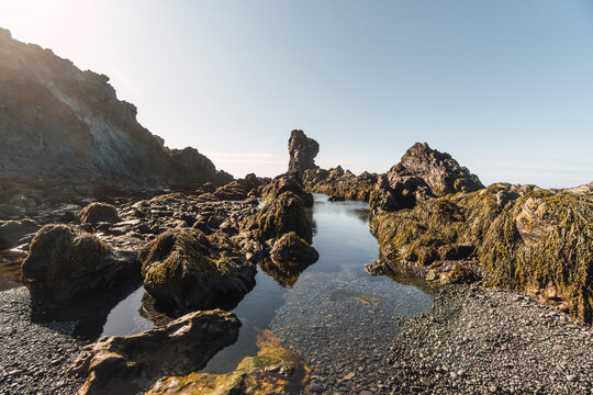 Rocky tidal pool on Iceland coastline at low tide