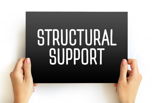 STRUCTURAL SUPPORT text held in hands. Conceptual image for construction, architecture, internal body framework, engineering, or foundational strength in business and health sectors.