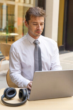Young businessman work on laptop in cafe