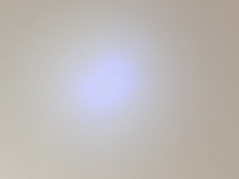 Smooth wall surface featuring a soft central spotlight beam with subtle natural texture. Minimalist backdrop for graphic design, product showcase placement, abstract visual presentation, and copy spac