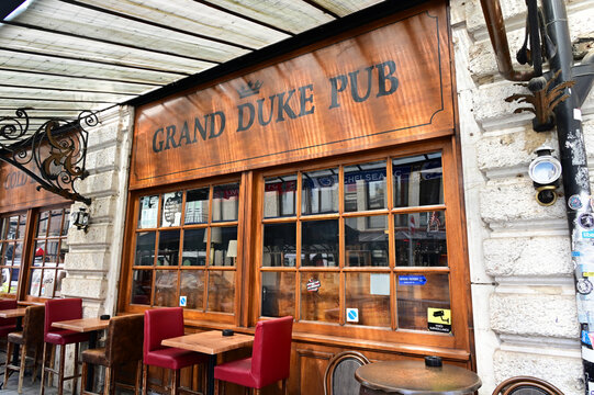 Geneva, Switzerland, Europe - 05.2026 : Irish-style Grand Duke Pub open since 1985, Art Nouveau style glass roofing, outdoor tables, Rue de Monthoux in city center near Cornavin train station