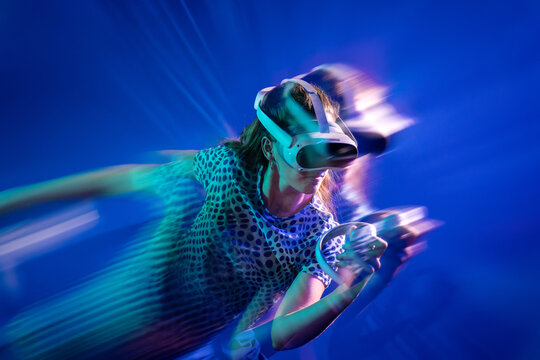 Young woman use virtual reality headset with motion blur