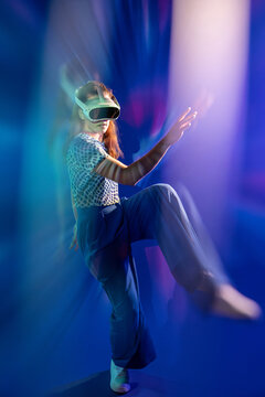 Young woman explore virtual reality in neon light