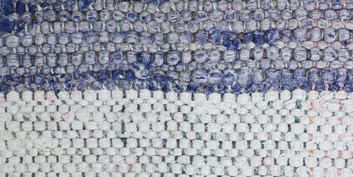 Handmade blue denim and white cotton rag rug textile texture. 