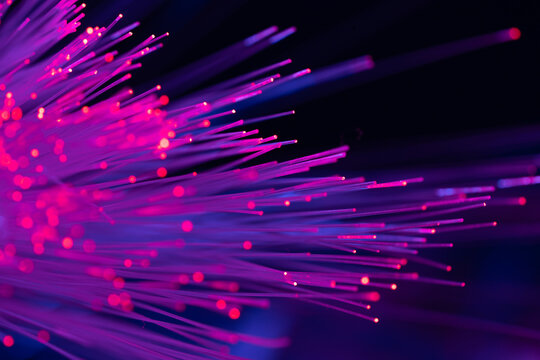 Vibrant fiber optic strands on dark technology background