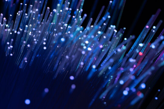 Fiber optics technology background with glowing blue light