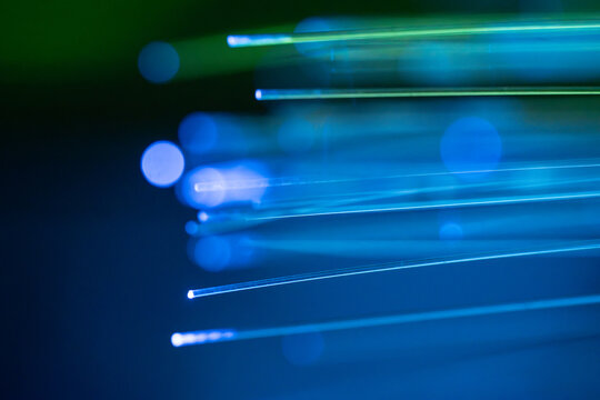 Fiber optic light strands on dark technology background
