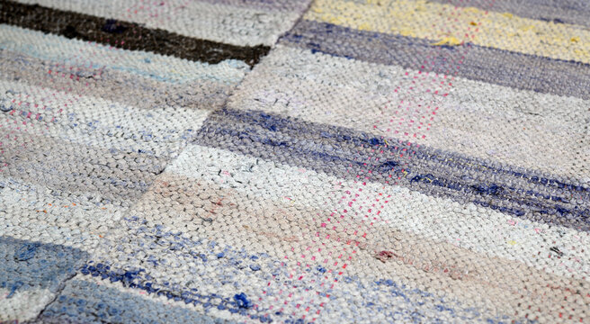 Handmade blue denim and white cotton rag rug textile texture. 